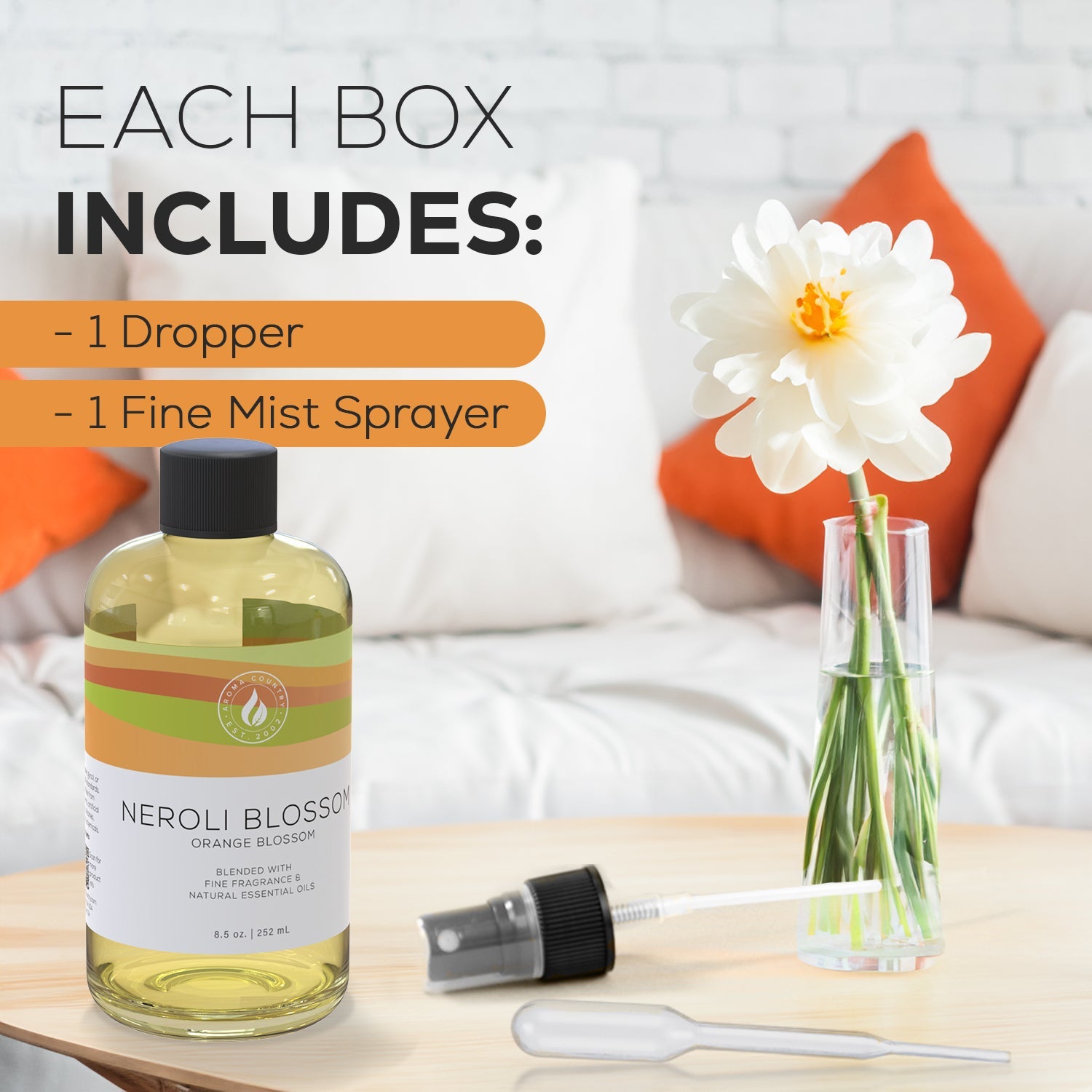 Neroli Blossom scent bottle displayed with a fine mist sprayer and dropper beside a fresh orange-accented floral setting, emphasizing full kit inclusions.