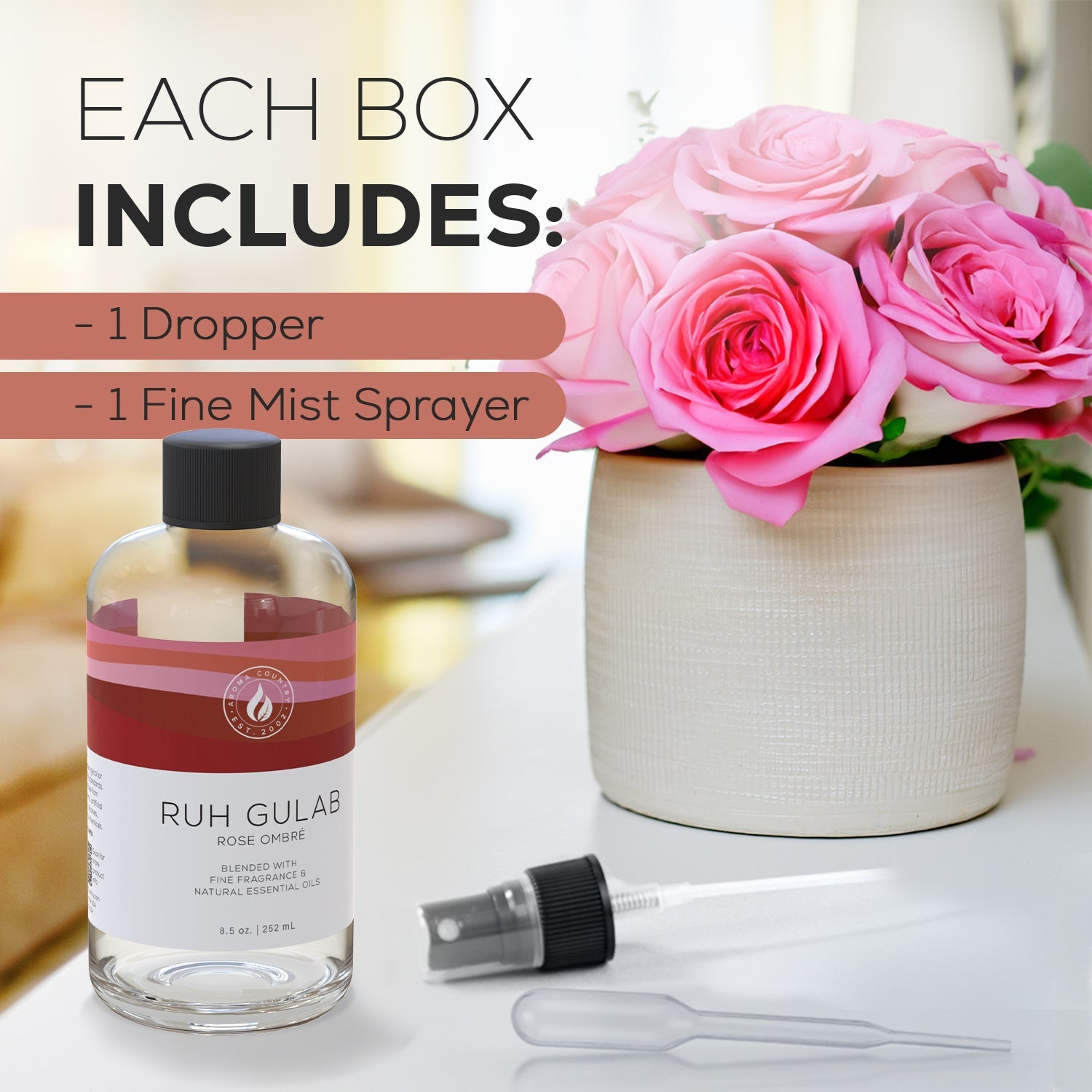 Ruh Gulab Rose Ombré essential oil kit with dropper and fine mist sprayer next to a bouquet of pink roses.
